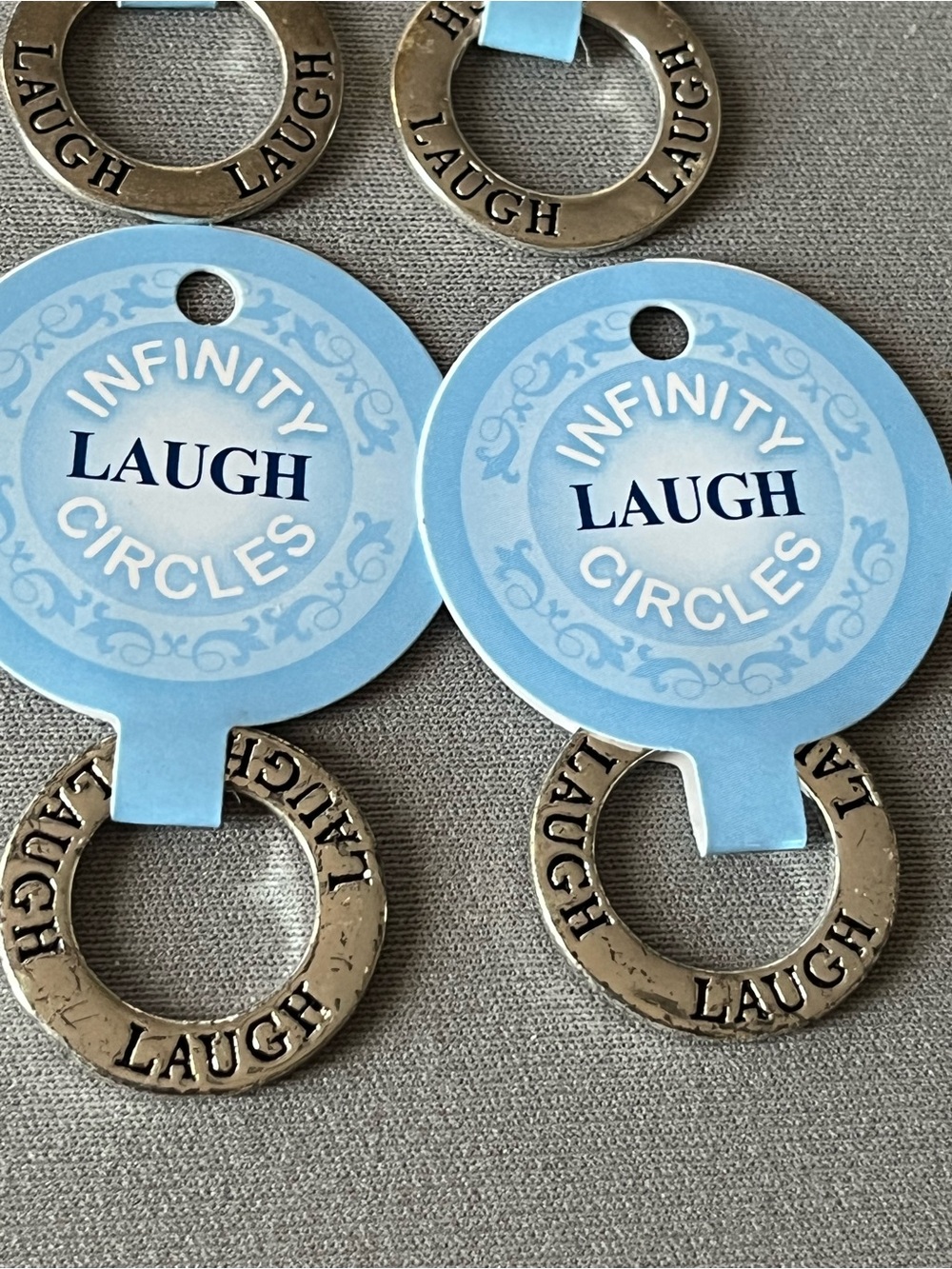 NWT nine infinity circles imprinted with laugh.  Layered in sterling silver.
